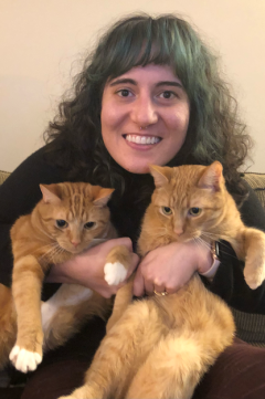 ms. a with two orange tabby cats